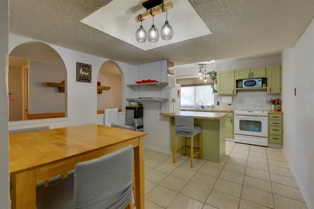 a kitchen that has a table and chairs in it