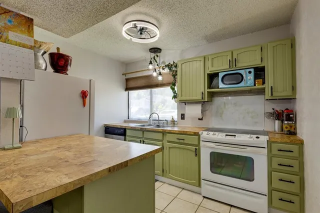 a kitchen with a stove a microwave and wooden cabinets