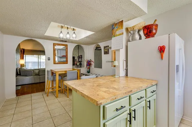 a view of kitchen with furniture and refrigerator