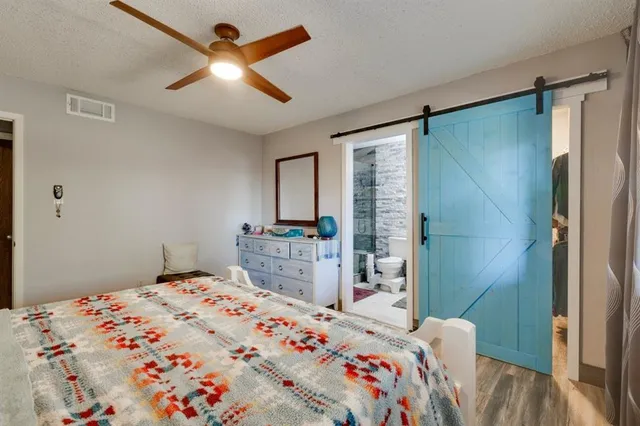 a bedroom that has a bed and a chandelier