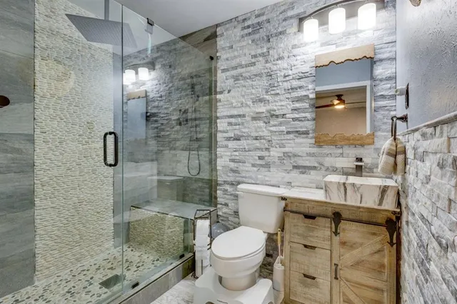 a bathroom with a sink toilet and shower