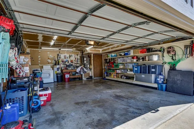 a view of a backyard with table and chairs couches with wooden fence and plants