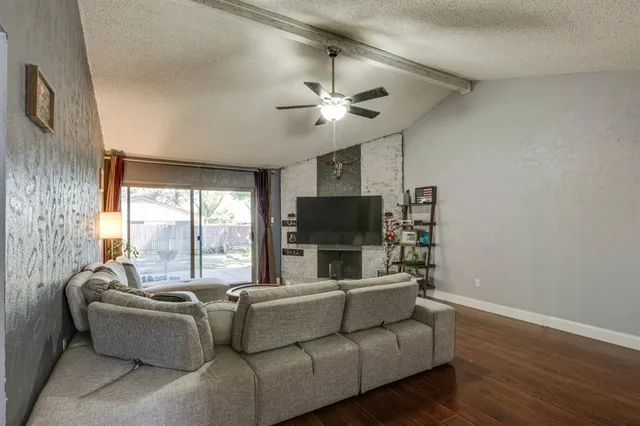 a living room with furniture a flat screen tv and a large window