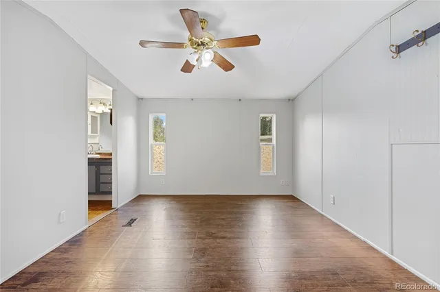wooden floor in an empty room with a window