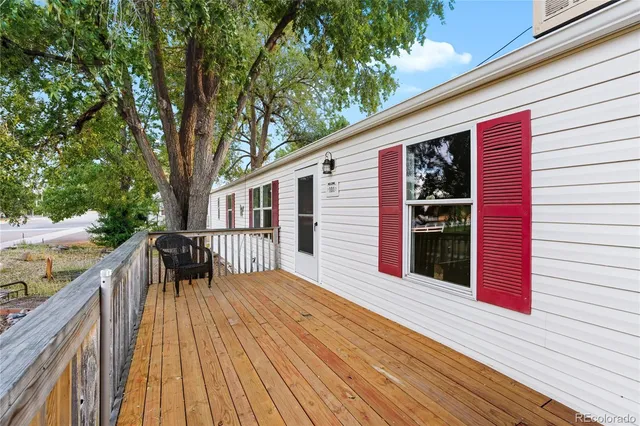 a balcony with wooden floor and fence