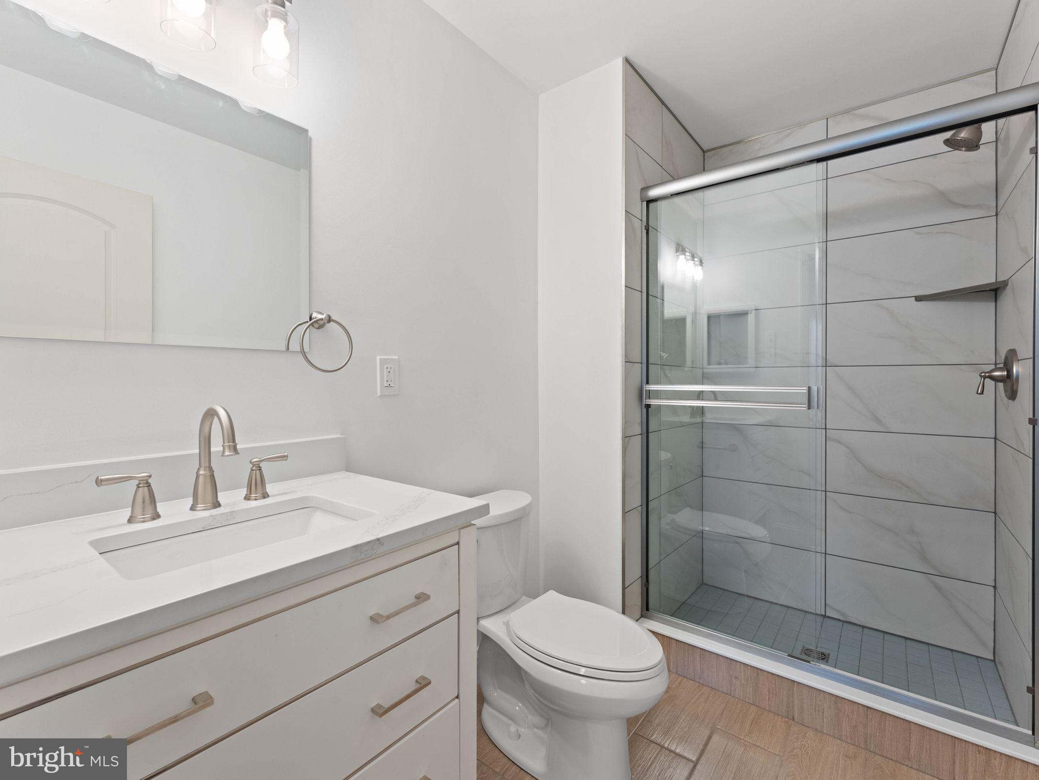 617 Caribbean Way Williamstown, NJ 08094 - Photo 17 of 26 a bathroom with a sink a toilet and shower
