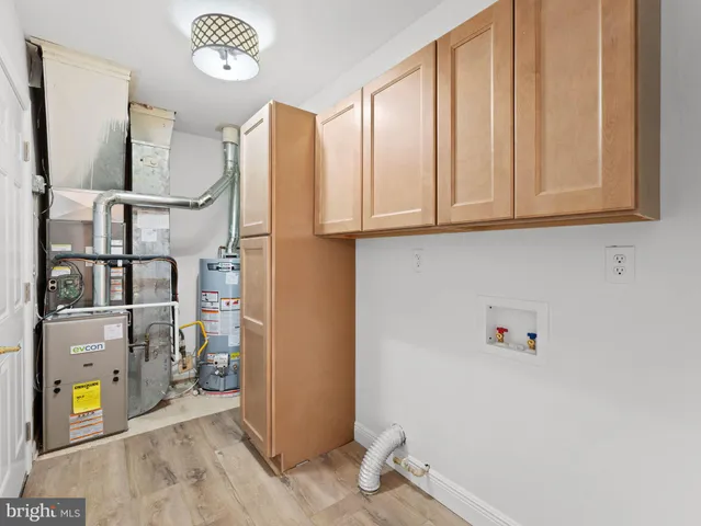 a view of storage and utility room with a window
