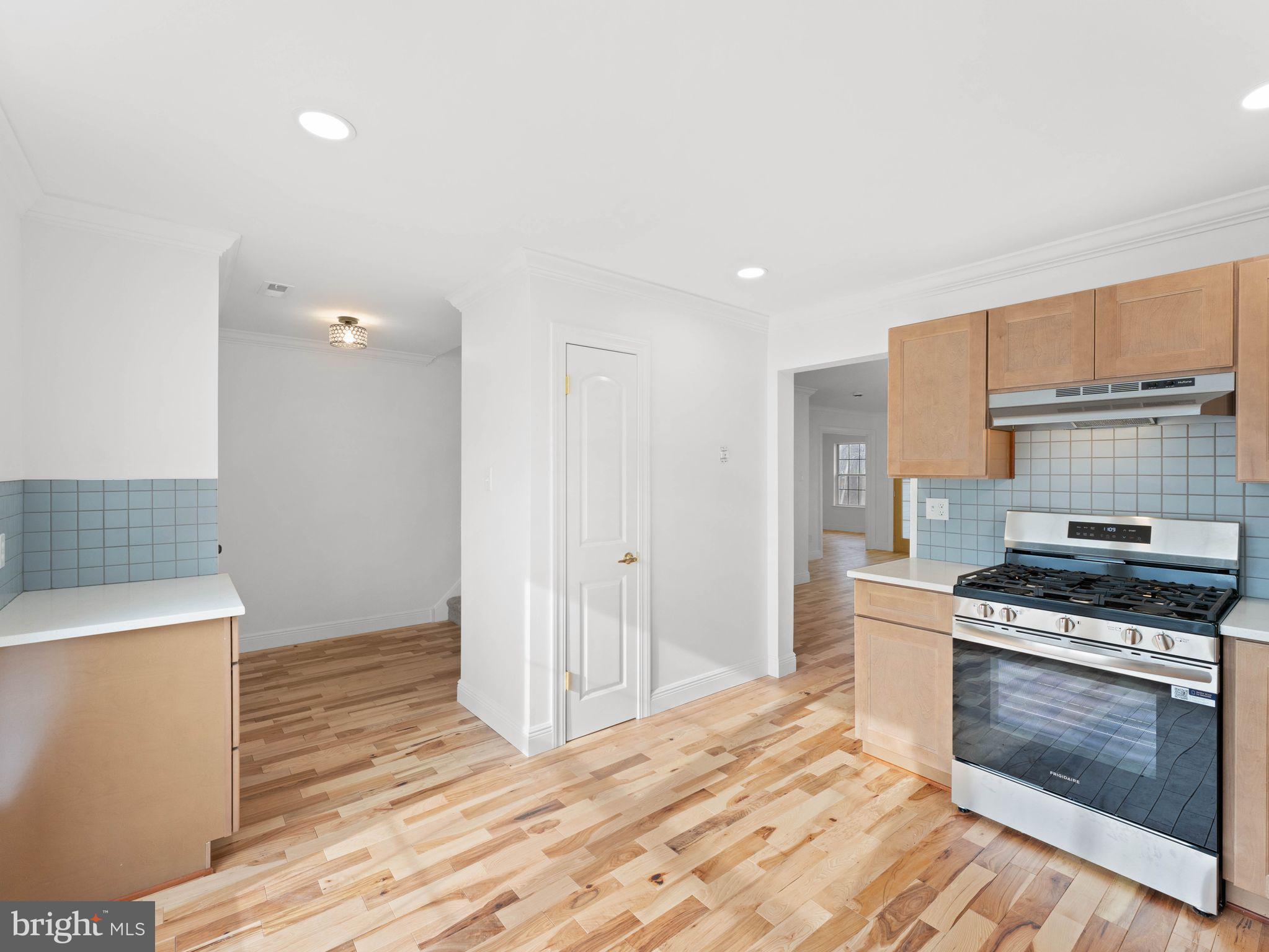 617 Caribbean Way Williamstown, NJ 08094 - Photo 7 of 26 a kitchen with granite countertop a stove and a refrigerator