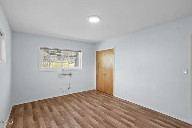 a view of an empty room and wooden floor