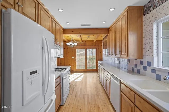 a view of a kitchen with a sink and wooden floor