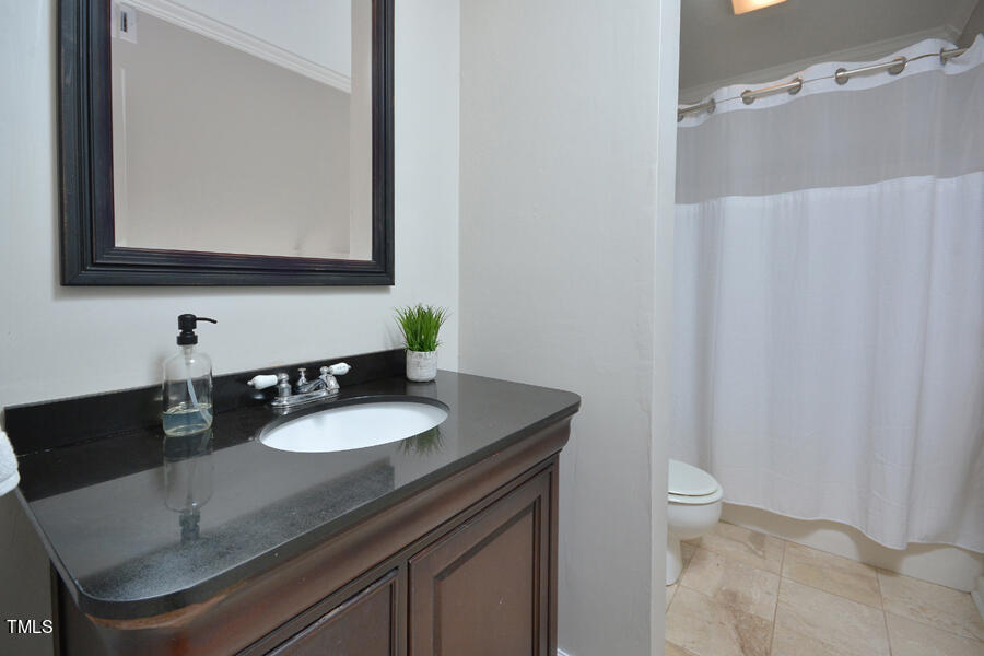 3702 Chimney Ridge Place, Unit 105 Durham, NC 27713 - Photo 20 of 32 Bathroom has newer, ceramic flooring, vanity, with granite, countertop, sink, hardware, and lighting. Shower hardware valve has been replaced.