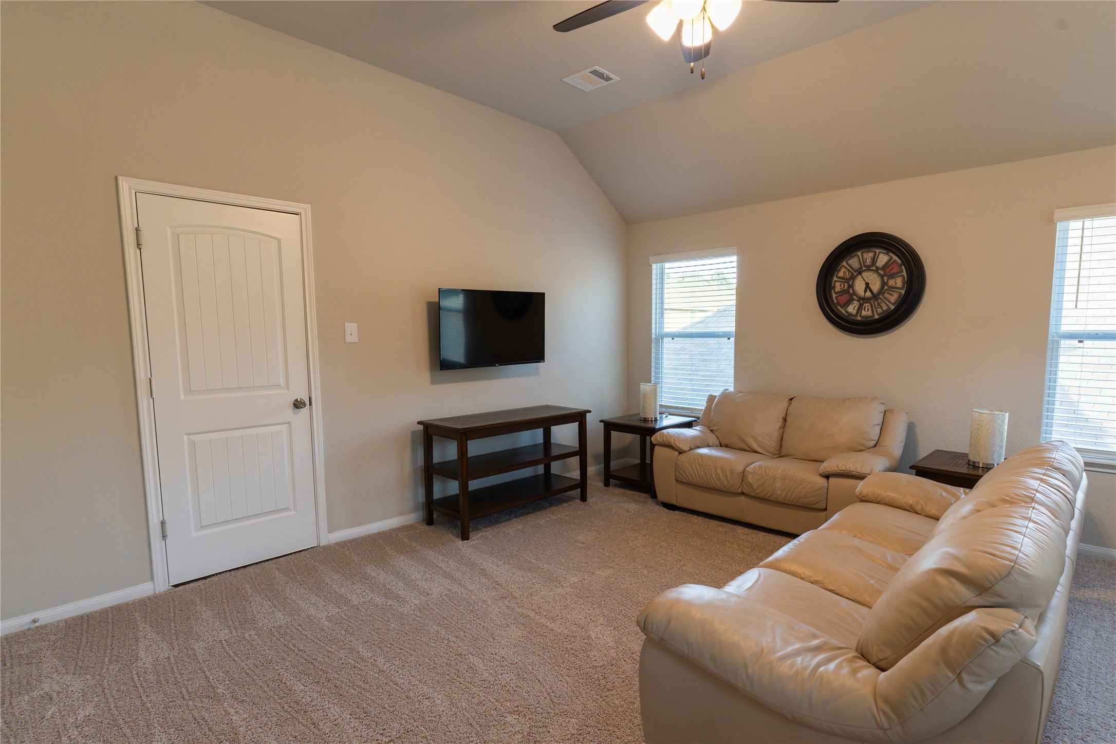2512 Austin Hills Conroe, TX 77304 - Photo 31 of 43 a living room with furniture a clock and a window