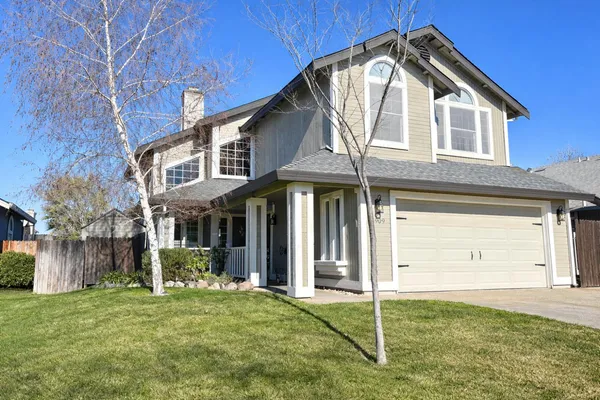 a view of a house with wooden fence