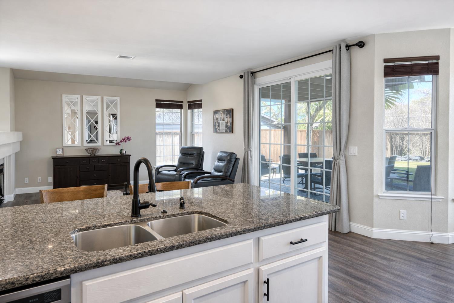 4909 Hidden Meadow Way Antelope, CA 95843 - Photo 12 of 35 a kitchen with granite countertop a sink and wooden floor