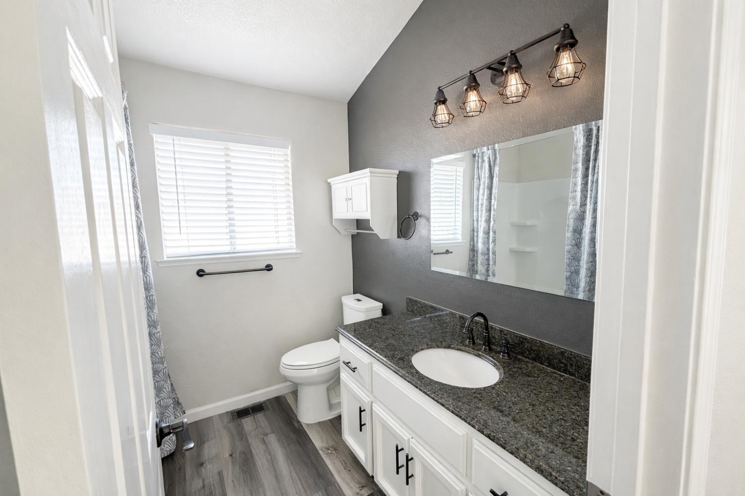 4909 Hidden Meadow Way Antelope, CA 95843 - Photo 21 of 35 a bathroom with a granite countertop sink toilet and mirror