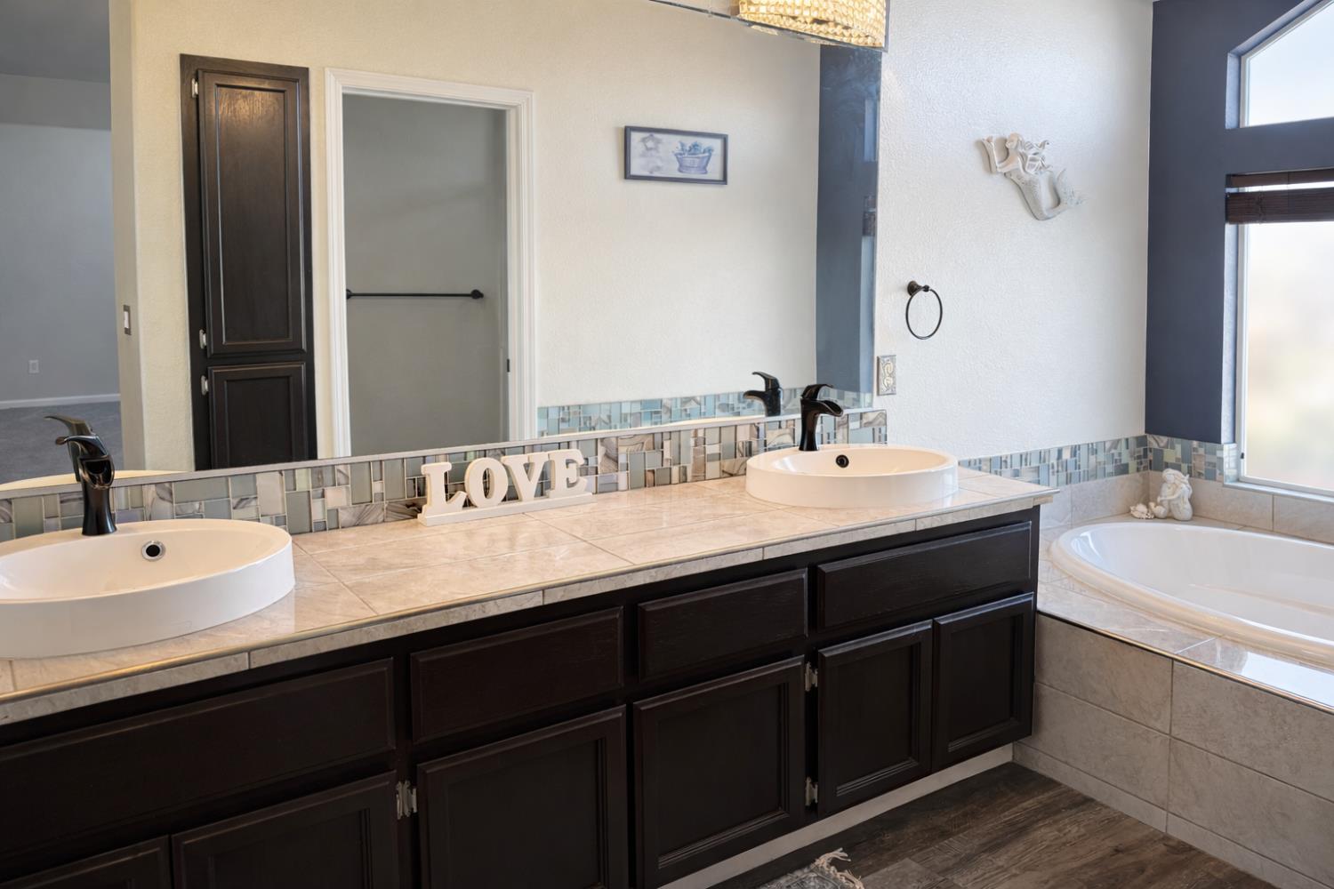 4909 Hidden Meadow Way Antelope, CA 95843 - Photo 28 of 35 a bathroom with a double vanity sink and a mirror