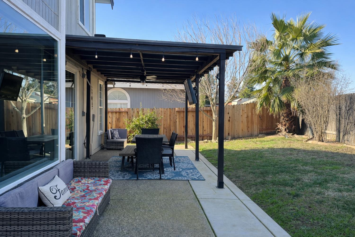4909 Hidden Meadow Way Antelope, CA 95843 - Photo 32 of 35 a view of a patio with table and chairs potted plants with wooden floor and fence