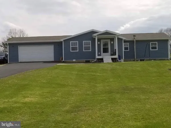 a view of a house with a garden and yard