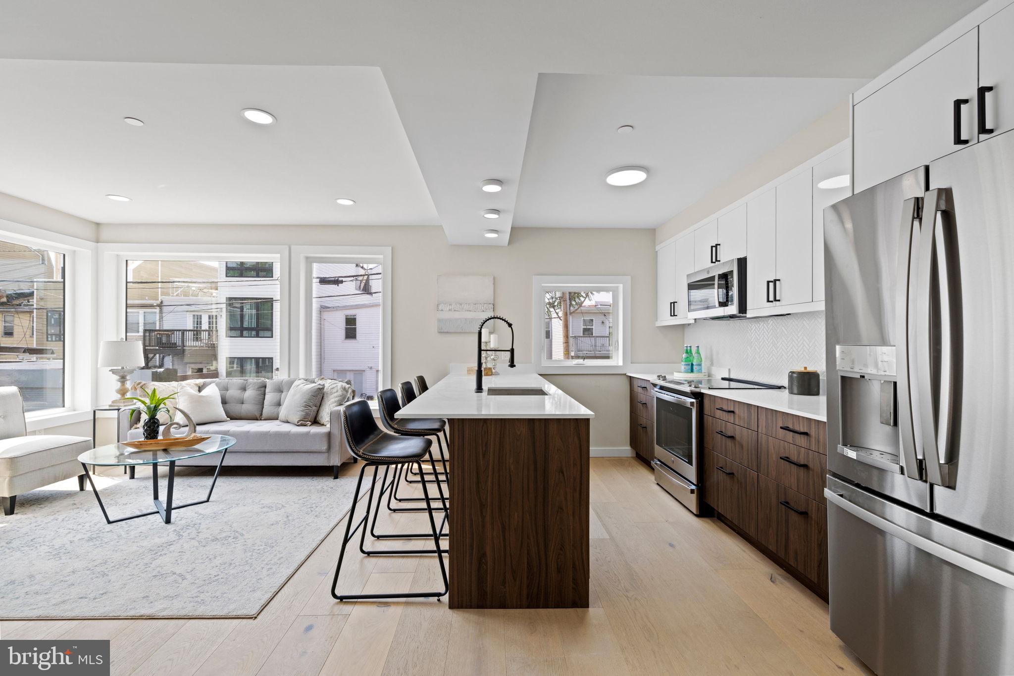 919 12th Street Northeast, Unit 304 Washington, DC 20002 - Photo 1 of 15 a living room with stainless steel appliances granite countertop furniture wooden floor and a window