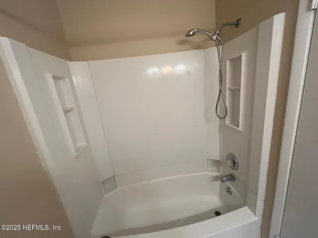 a bathroom with a shower and a bath tub