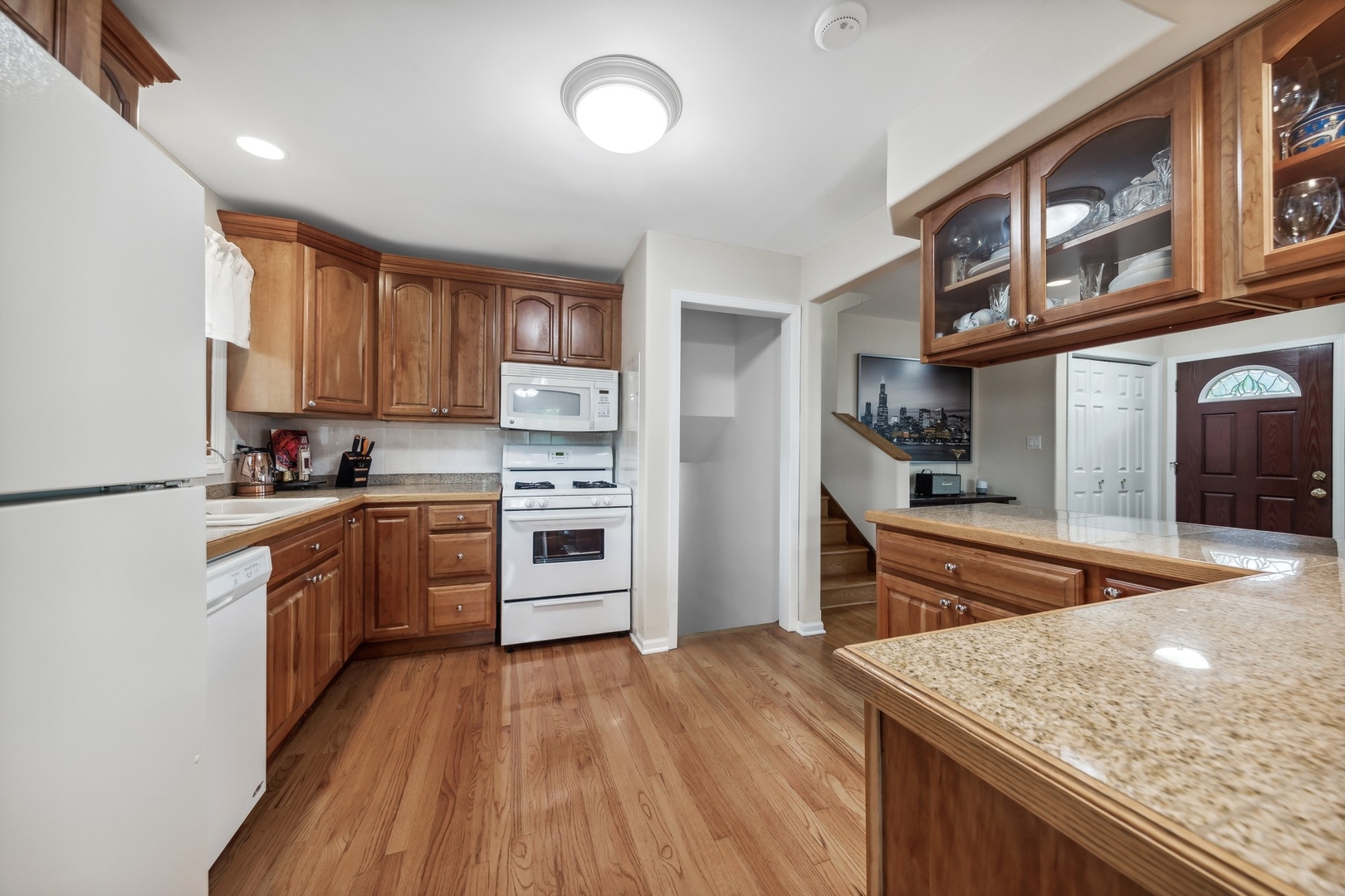 141 Hidden View Drive Westmont, IL 60559 - Photo 5 of 19 a kitchen with stainless steel appliances granite countertop wooden cabinets and a granite counter tops with a large window