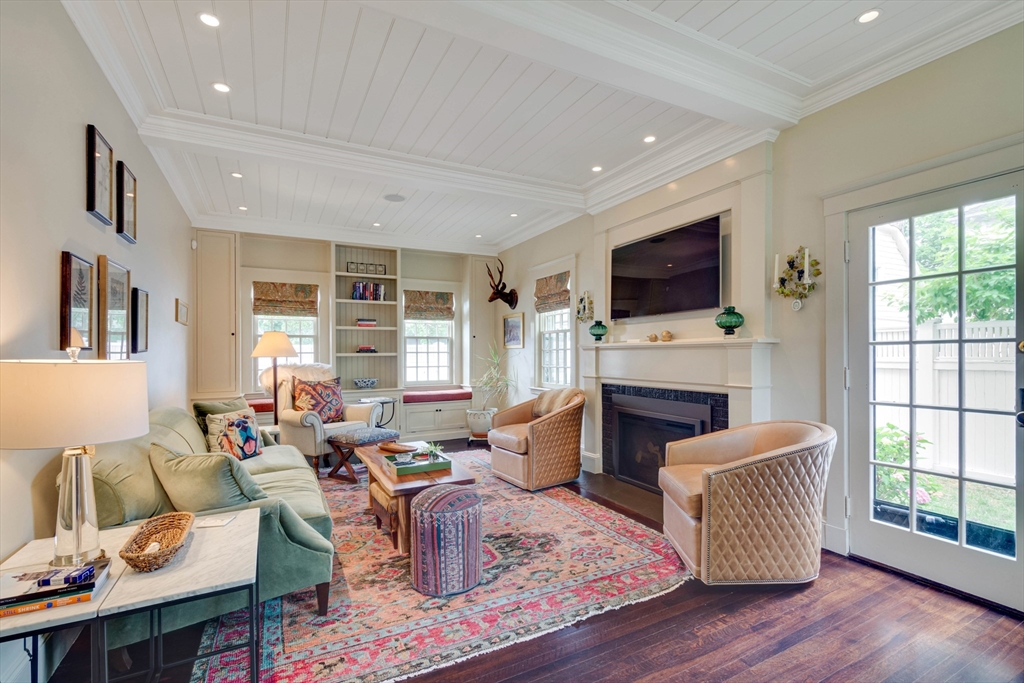 24 Cleveland Road Needham, MA 02492 - Photo 15 of 42 a living room with furniture a fireplace and a flat screen tv