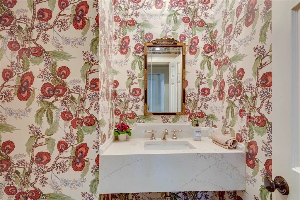 24 Cleveland Road Needham, MA 02492 - Photo 18 of 42 a bathroom with a sink and a mirror