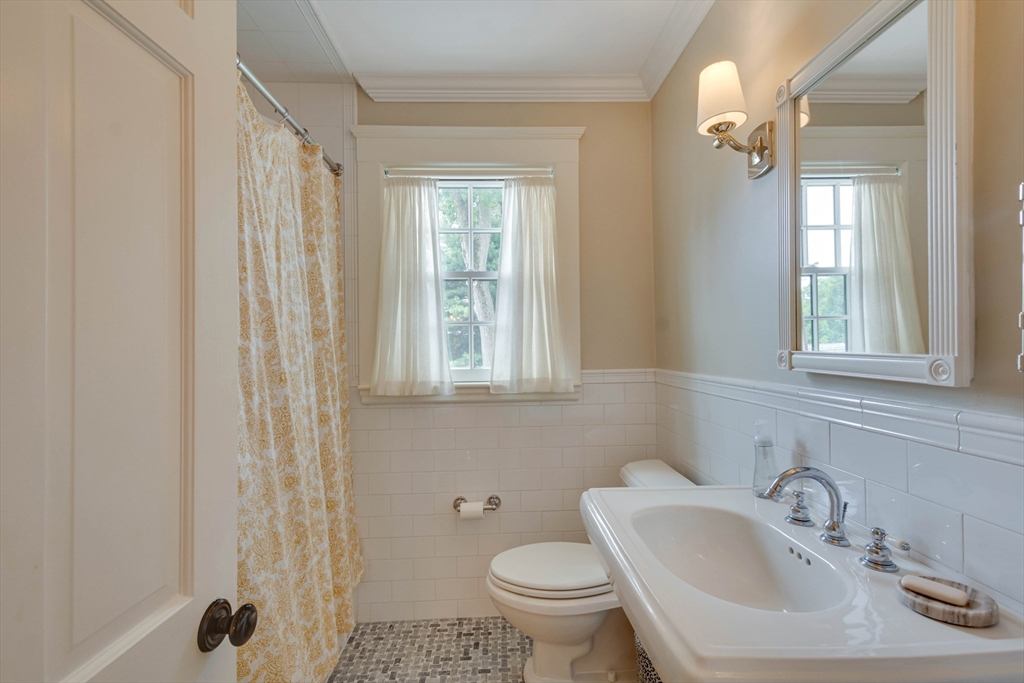 24 Cleveland Road Needham, MA 02492 - Photo 22 of 42 a bathroom with a sink toilet and shower