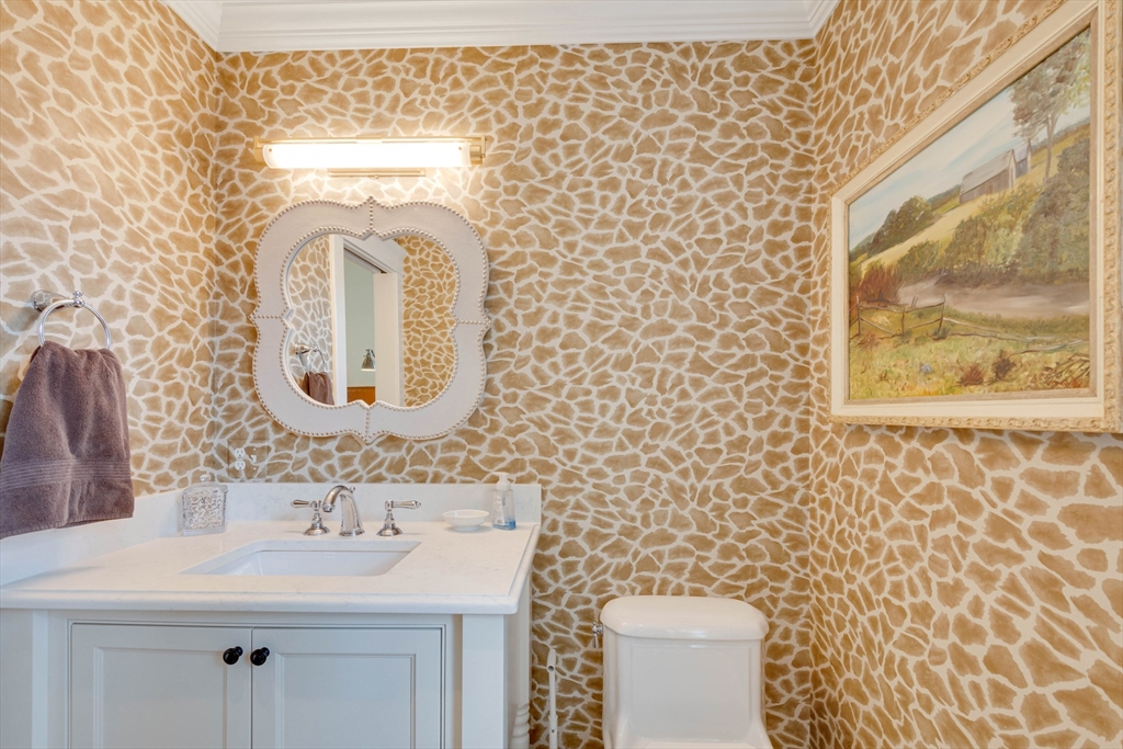 24 Cleveland Road Needham, MA 02492 - Photo 27 of 42 a bathroom with a sink toilet and mirror