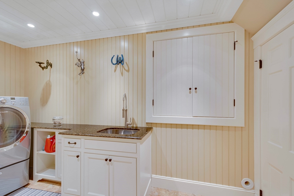 24 Cleveland Road Needham, MA 02492 - Photo 29 of 42 a bathroom with a sink and a mirror