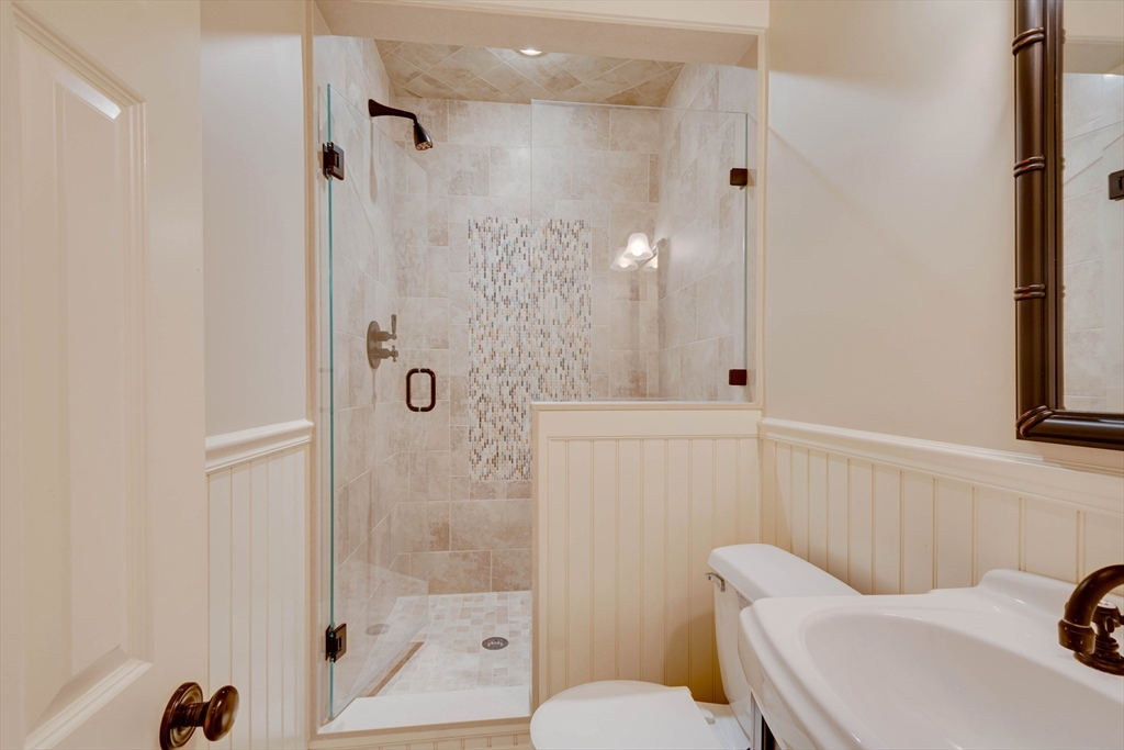 24 Cleveland Road Needham, MA 02492 - Photo 30 of 42 a bathroom with a toilet a sink and shower