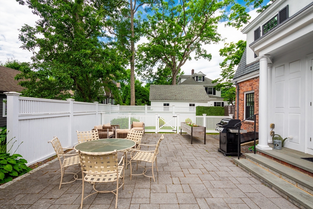 24 Cleveland Road Needham, MA 02492 - Photo 38 of 42 a backyard of a house with table and chairs