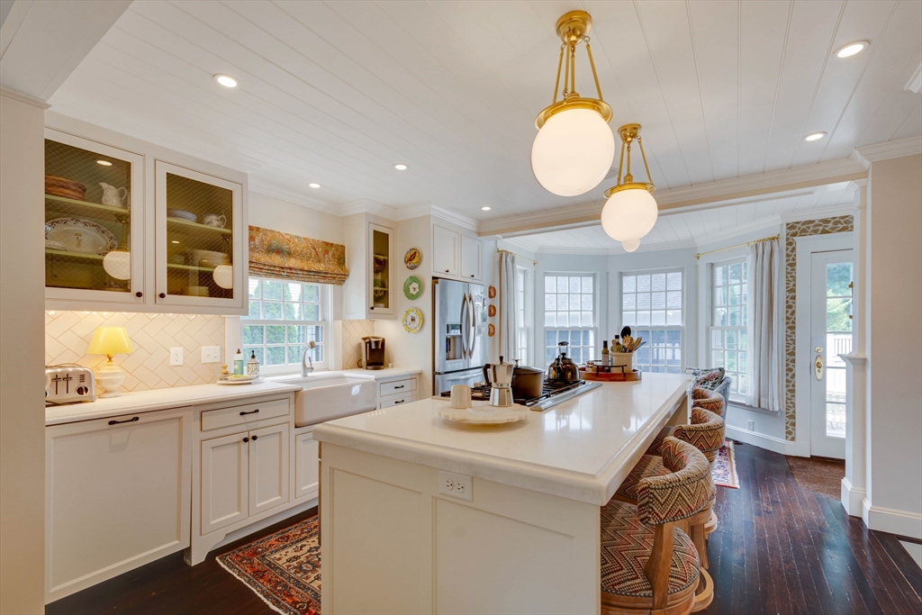 24 Cleveland Road Needham, MA 02492 - Photo 9 of 42 a kitchen with counter top space a sink cabinets and wooden floor