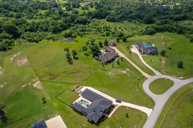 an aerial view of a house with a swimming pool