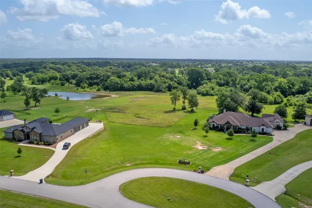 an aerial view of a golf course with chairs