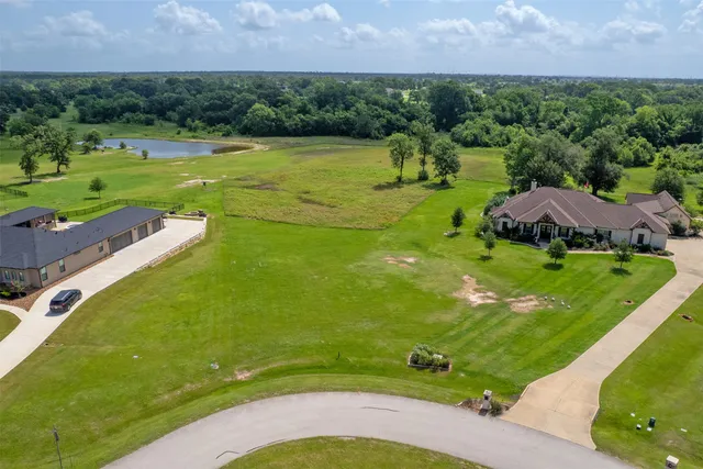an aerial view of a golf course with huge green field