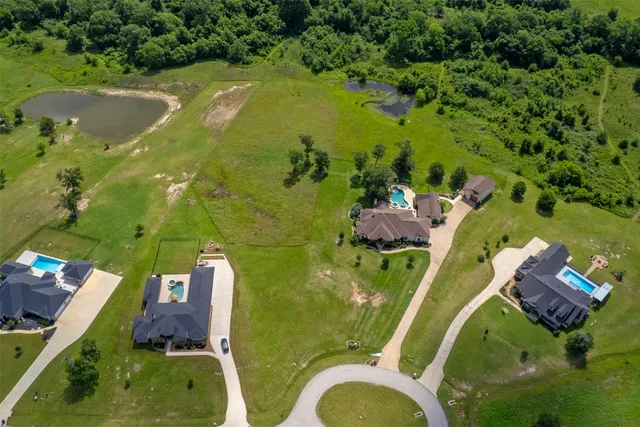 an aerial view of a house with a yard swimming pool outdoor seating and yard