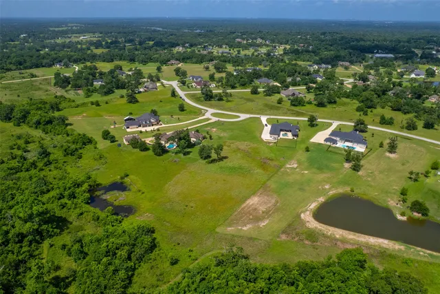an aerial view of a houses with a lake