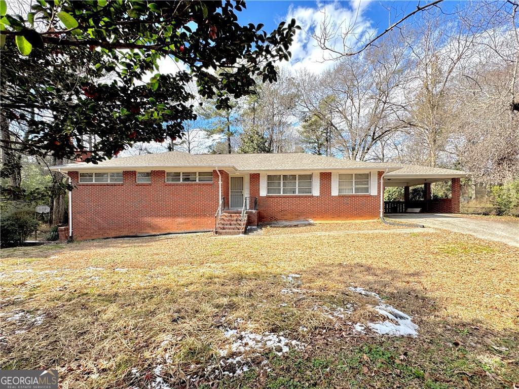 a view of a house with a yard covered with snow in front of house