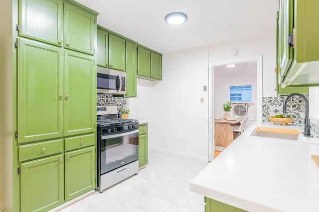 a kitchen with a refrigerator and a sink