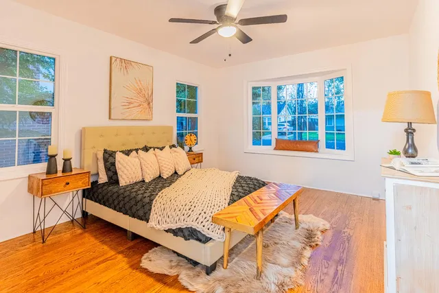 a bedroom with a bed and wooden floor