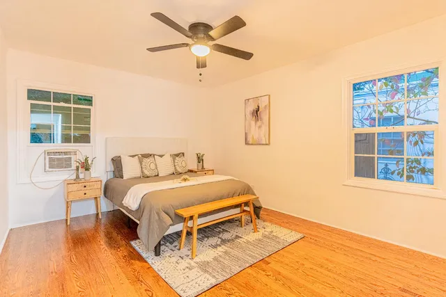 a bedroom with a bed and a large window