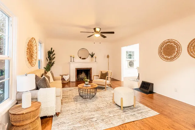 a living room with furniture a fireplace and a table