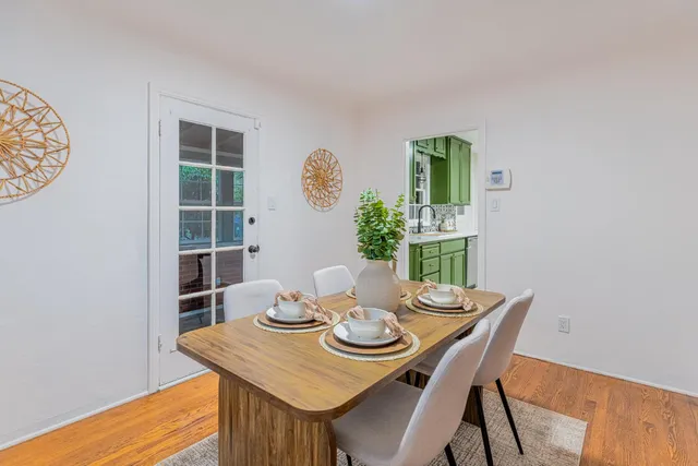 a view of a dining room with furniture and wooden floor
