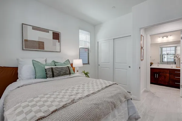 a bedroom with a bed and a mirror