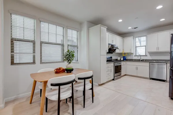 a kitchen with a sink cabinets and window