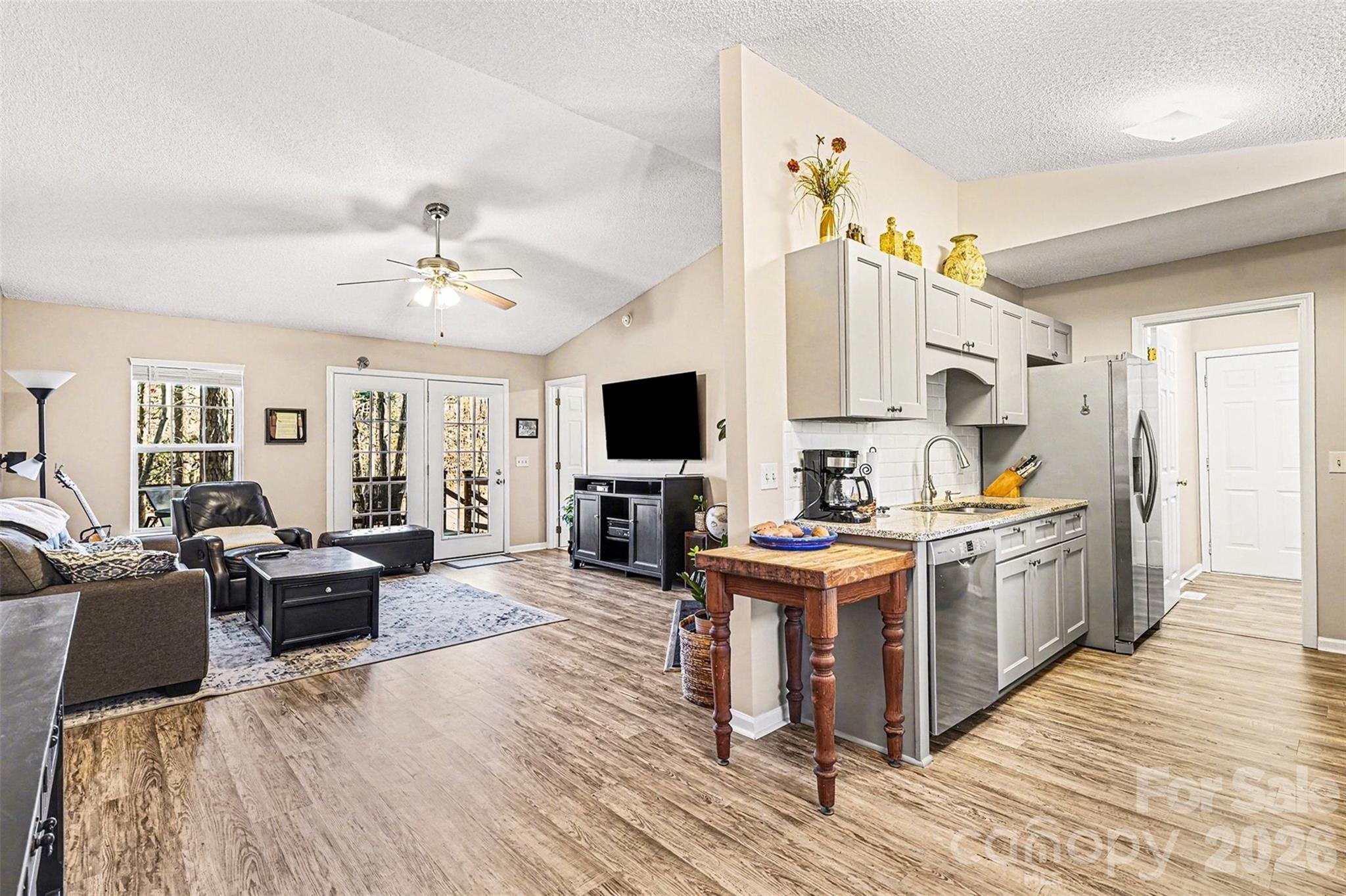 228 Creek View Road Mooresville, NC 28117 - Photo 11 of 40 a view of living room kitchen with stainless steel appliances furniture and flat screen tv