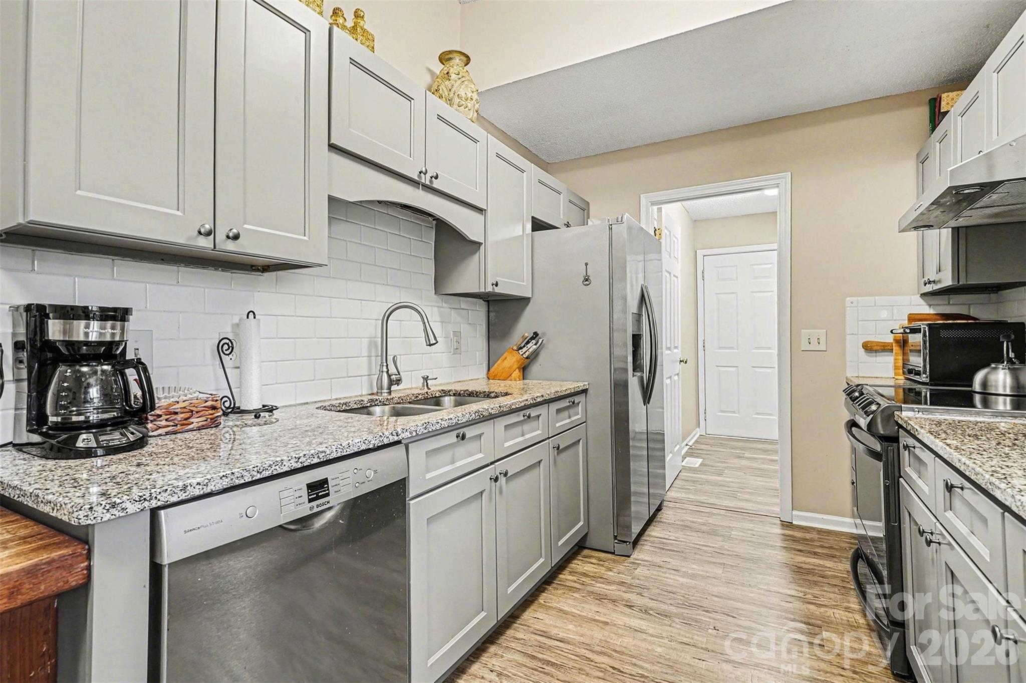 228 Creek View Road Mooresville, NC 28117 - Photo 13 of 40 a kitchen with stainless steel appliances granite countertop a sink stove and refrigerator