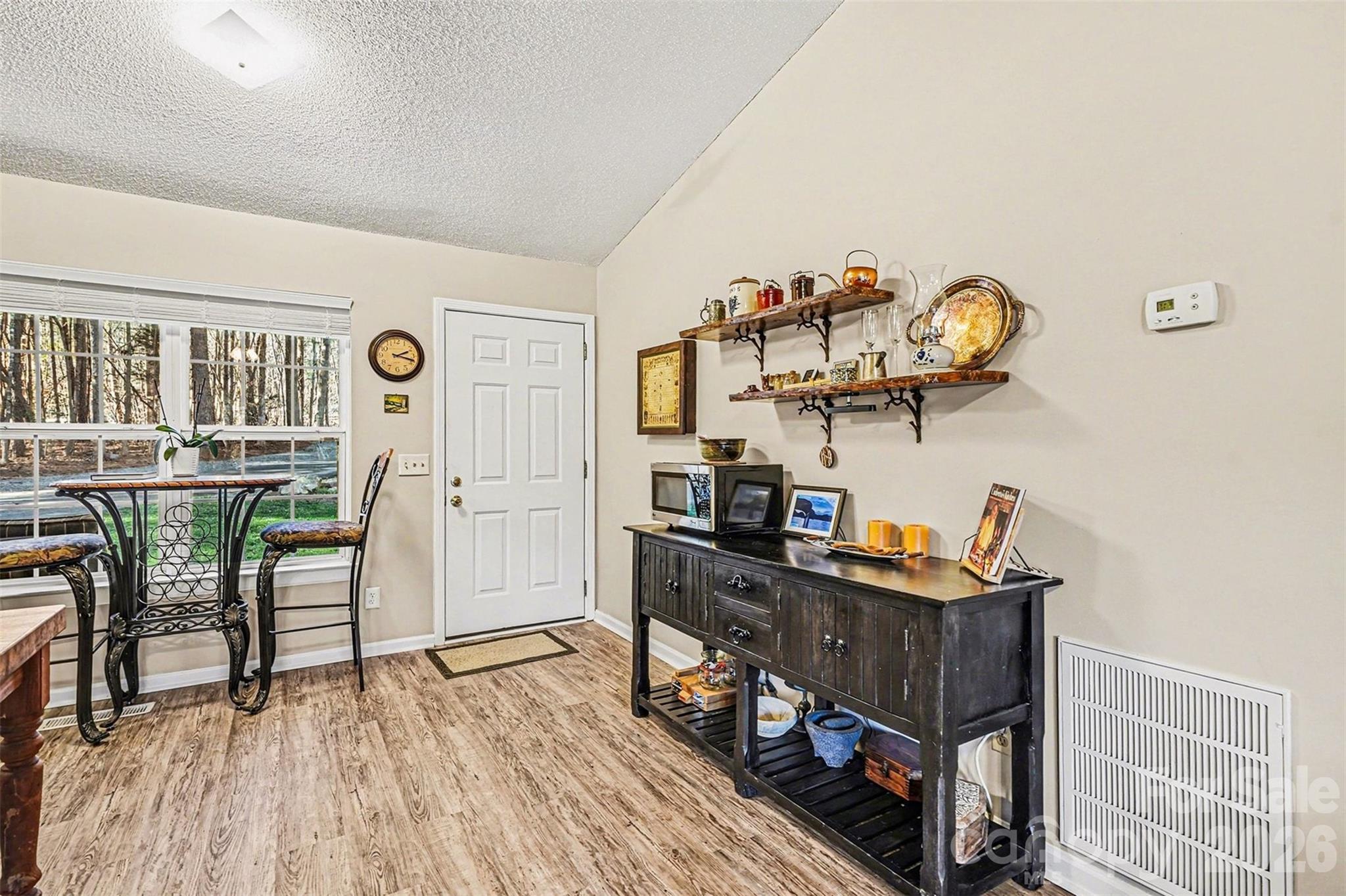 228 Creek View Road Mooresville, NC 28117 - Photo 16 of 40 a view of a dining room with furniture and wooden floor