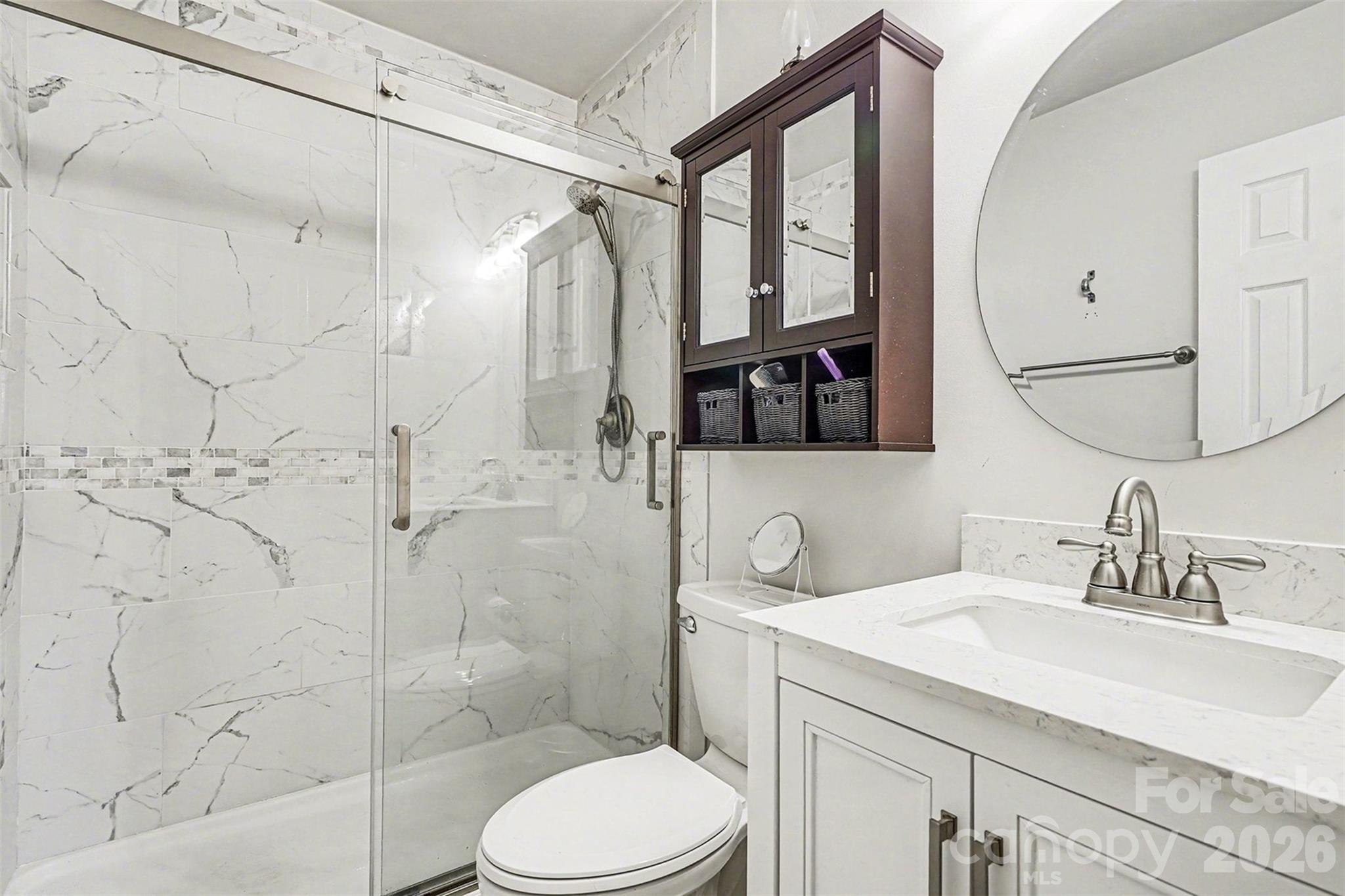 228 Creek View Road Mooresville, NC 28117 - Photo 20 of 40 a bathroom with a sink toilet vanity and shower